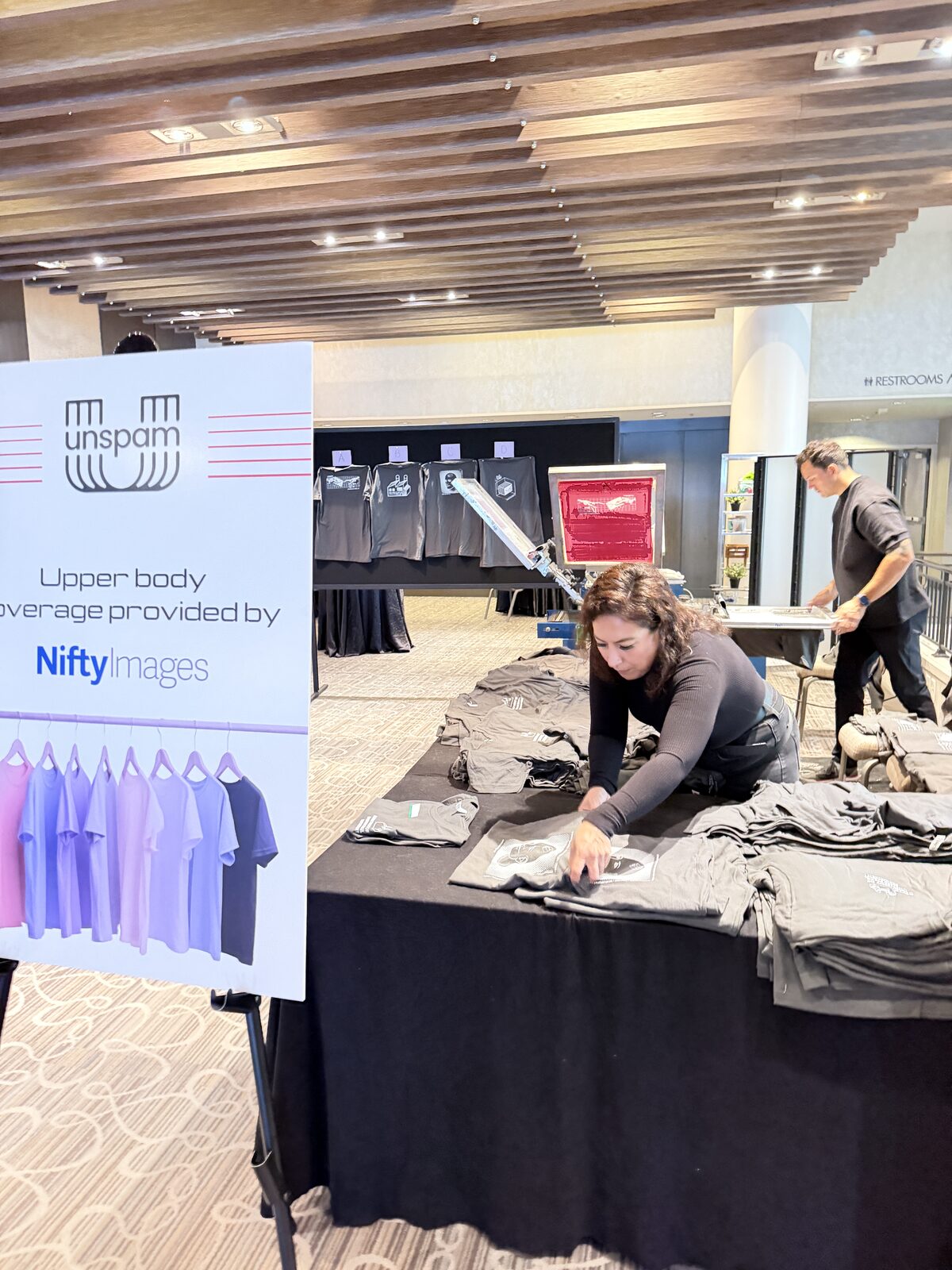 Conference shirt bar table stocked with custom printed shirts