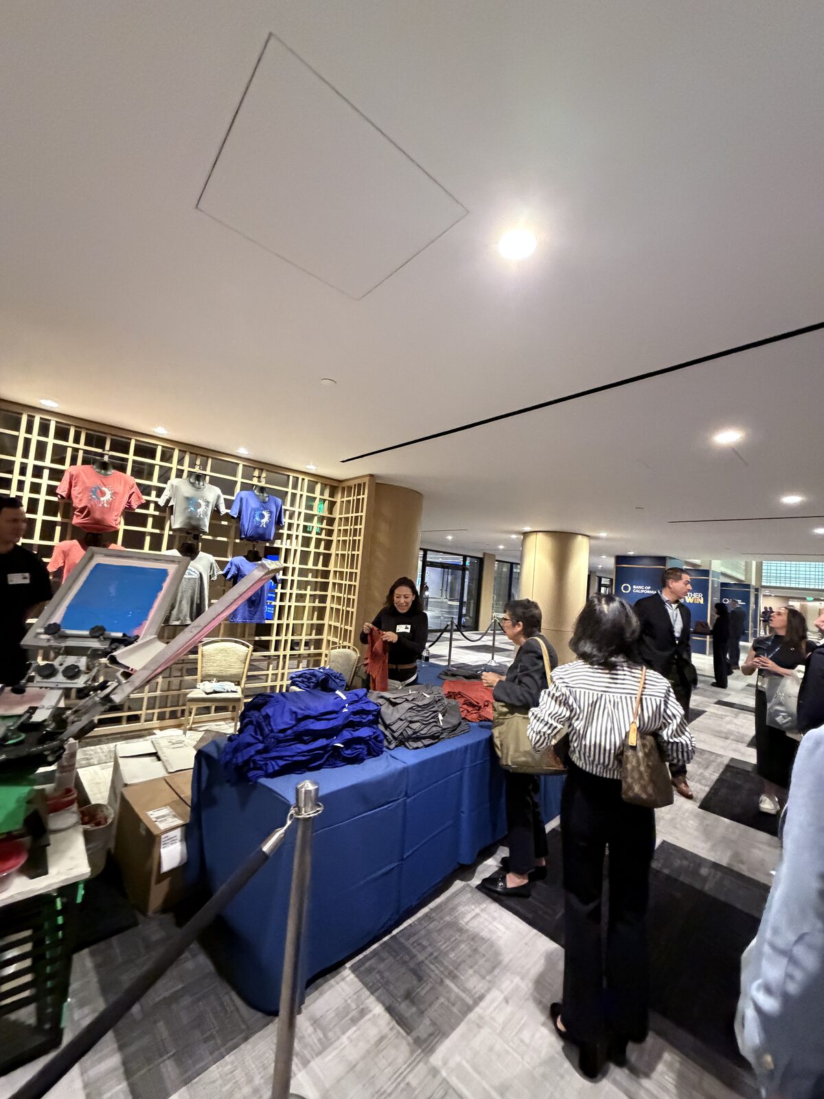 Guest receiving a custom printed shirt at an event shirt bar handoff